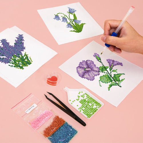 Diamond Painting - Cross-stitching kit with pre-printed patterns and materials on a pink background